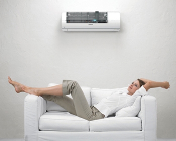 Woman sitting under an air conditioner in Perth