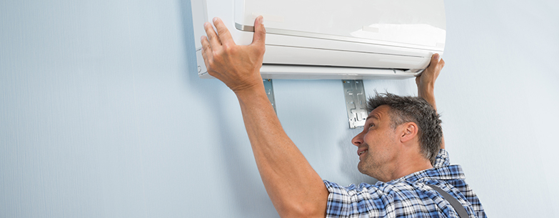 Man replacing air conditioner in Perth