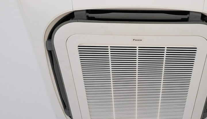 A ceiling cassette air conditioning unit installed on the roof of a home.