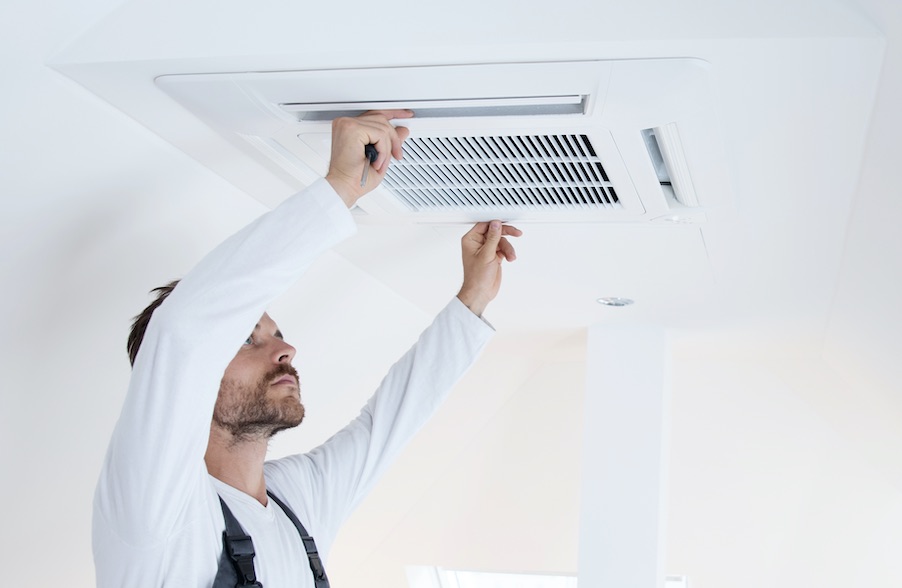 A ceiling cassette airconditioning system being installed.