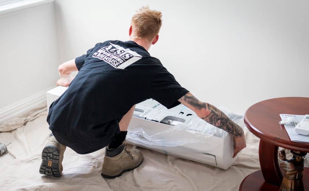 ACSIS Staff installing split-type air conditioner.