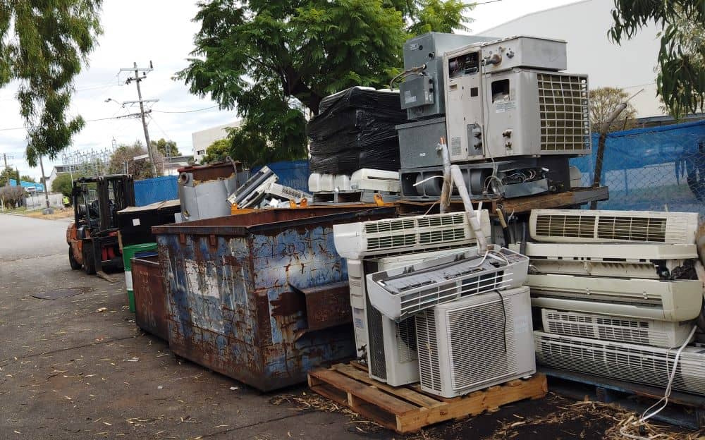 Pile of disposed air conditioners in a scrap yard.