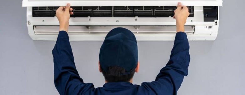 Service man checking air conditioner.