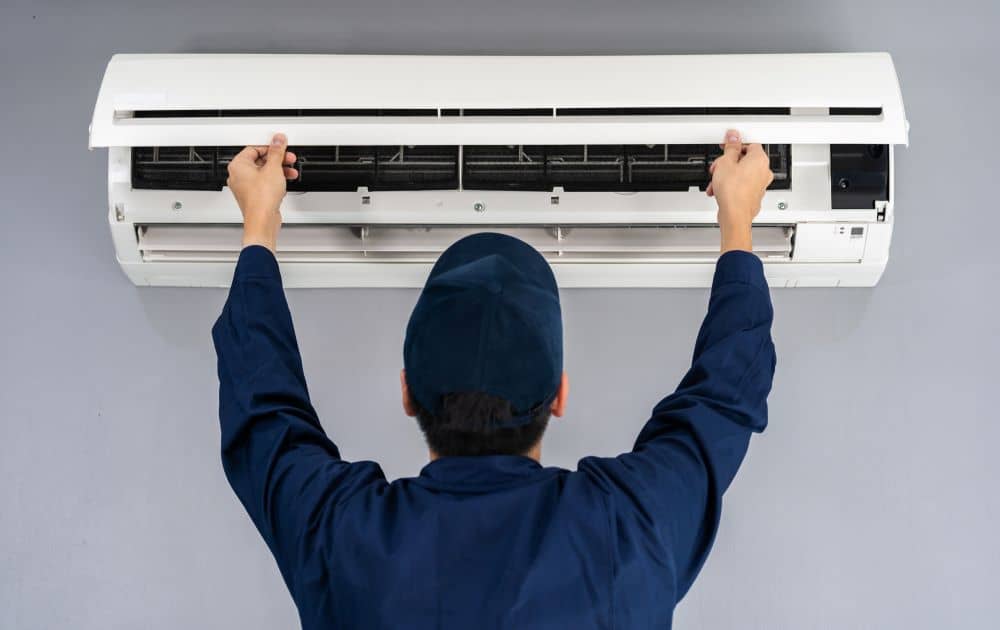 Service man checking air conditioner.