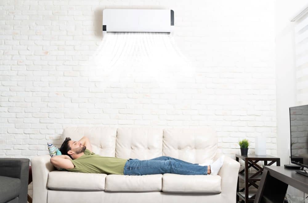 Man relaxing under air conditioner.