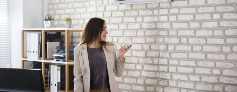 Employee turning AC on using remote control.