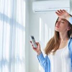 Woman using AC during summer.