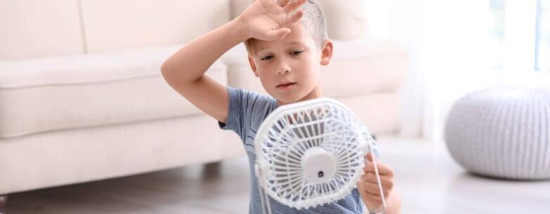 Child suffering from the summer heat indoors.