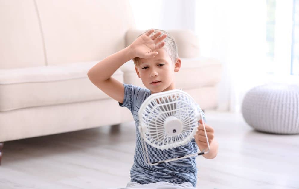 Child suffering from the summer heat indoors.