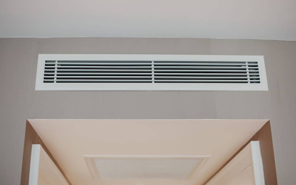 Ducted air-conditioner installed on wall.