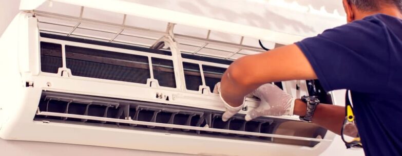 Technician checking air conditioner.