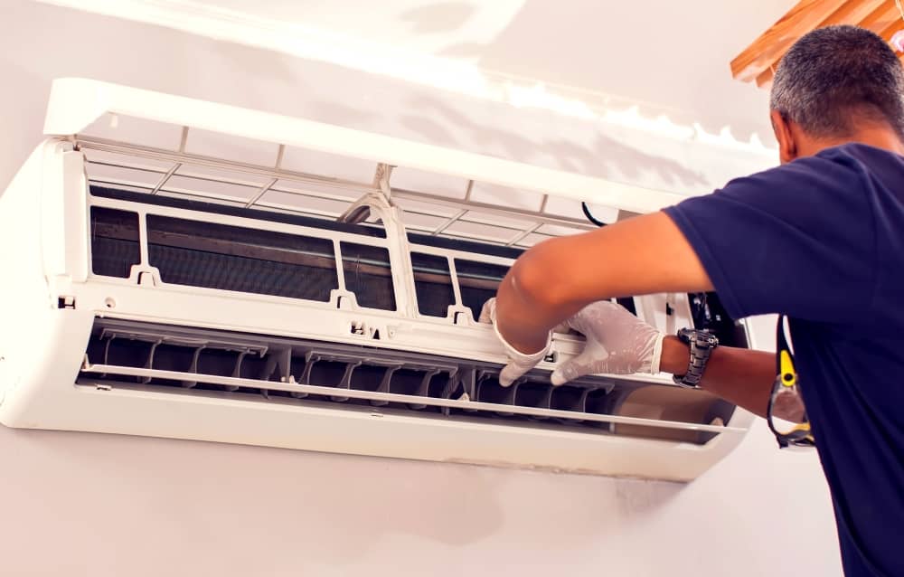 Technician checking air conditioner.