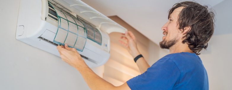 Man cleaning an aircon filter