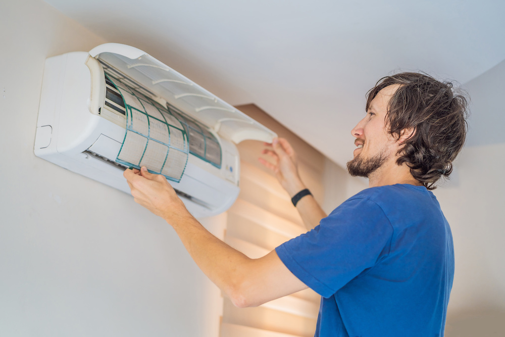 Man cleaning an aircon filter